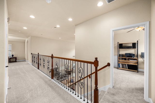 hall featuring baseboards, carpet, recessed lighting, and an upstairs landing