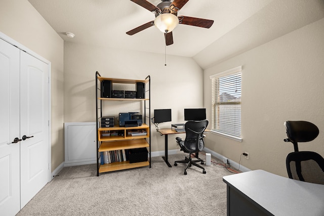 carpeted home office featuring a ceiling fan, baseboards, and vaulted ceiling