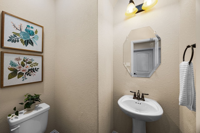bathroom featuring a sink and toilet