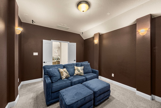 cinema room with vaulted ceiling, baseboards, carpet flooring, and visible vents