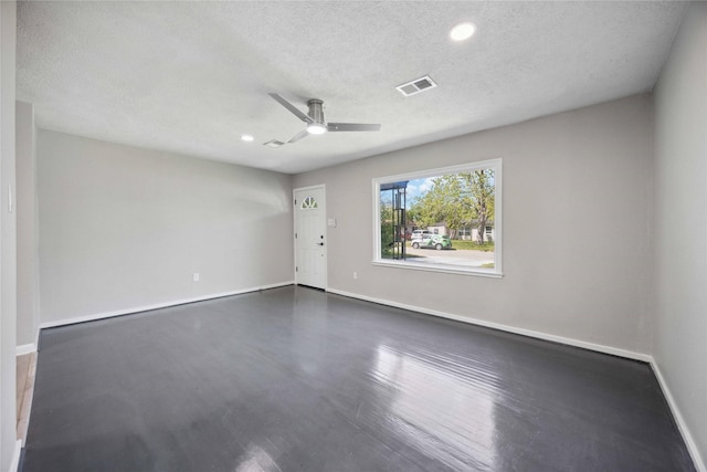 5206 Willow Glen Dr, Houston, TX 77033 - empty room featuring visible vents, baseboards, a ceiling fan, and a textured ceiling