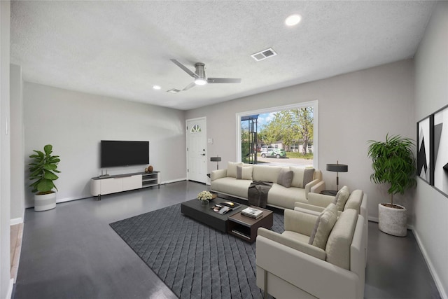 5206 Willow Glen Dr, Houston, TX 77033 - living room with ceiling fan, a textured ceiling, visible vents, recessed lighting, and baseboards