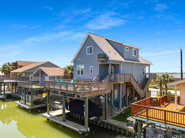 dock area featuring a deck with water view and boat lift