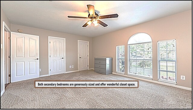411 Senna Ave, League City, TX 77573 - unfurnished bedroom featuring two closets, ceiling fan, baseboards, and carpet floors