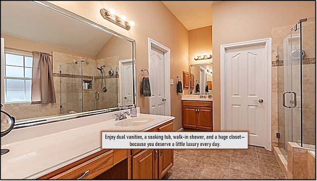full bath with a shower stall, two vanities, a sink, and lofted ceiling