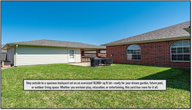 back of house with a patio area and a lawn