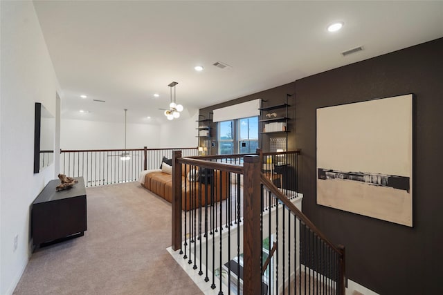 corridor featuring light carpet, an upstairs landing, visible vents, and recessed lighting