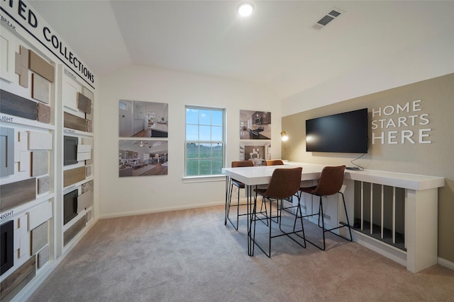 interior space with visible vents, baseboards, carpet floors, and lofted ceiling