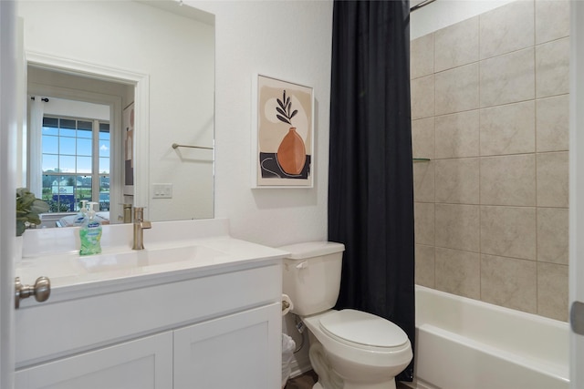 full bath featuring toilet, vanity, and shower / bath combo with shower curtain
