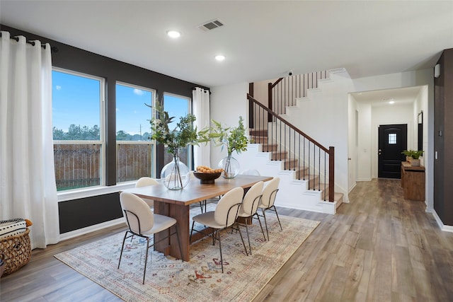 dining space with baseboards, recessed lighting, stairs, visible vents, and wood finished floors