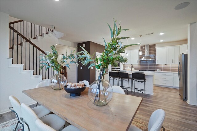 26723 Grandiflora Dr, Magnolia, TX 77355 - dining space featuring light wood-style flooring, stairs, recessed lighting, and baseboards