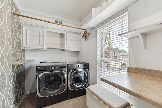 laundry area featuring visible vents, light tile patterned floors, separate washer and dryer, crown molding, and cabinet space