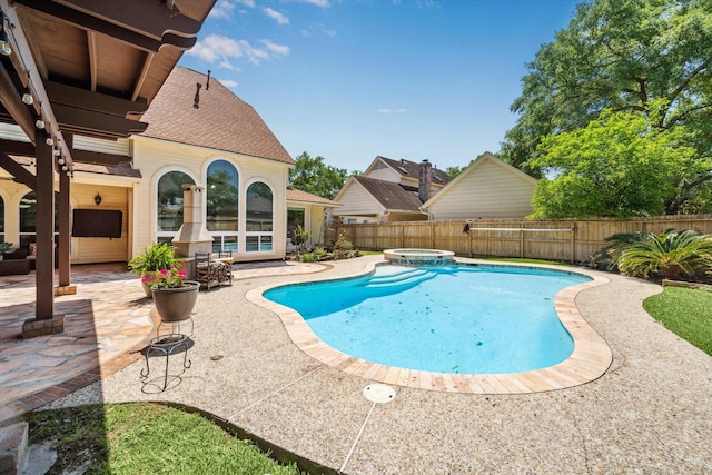 view of swimming pool with a patio area, a pool with connected hot tub, and a fenced backyard