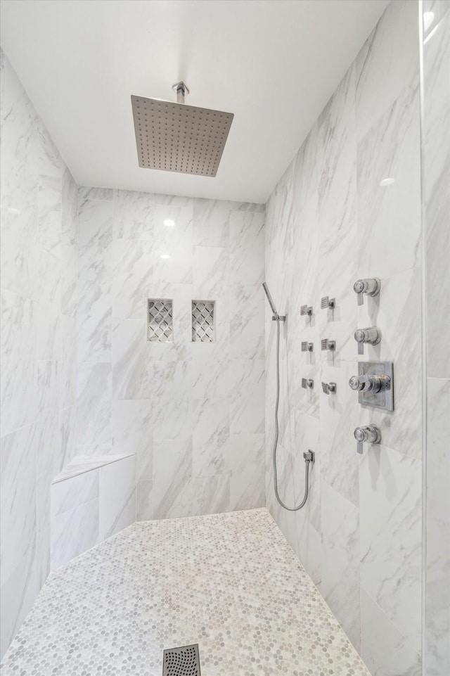 bathroom with tiled shower