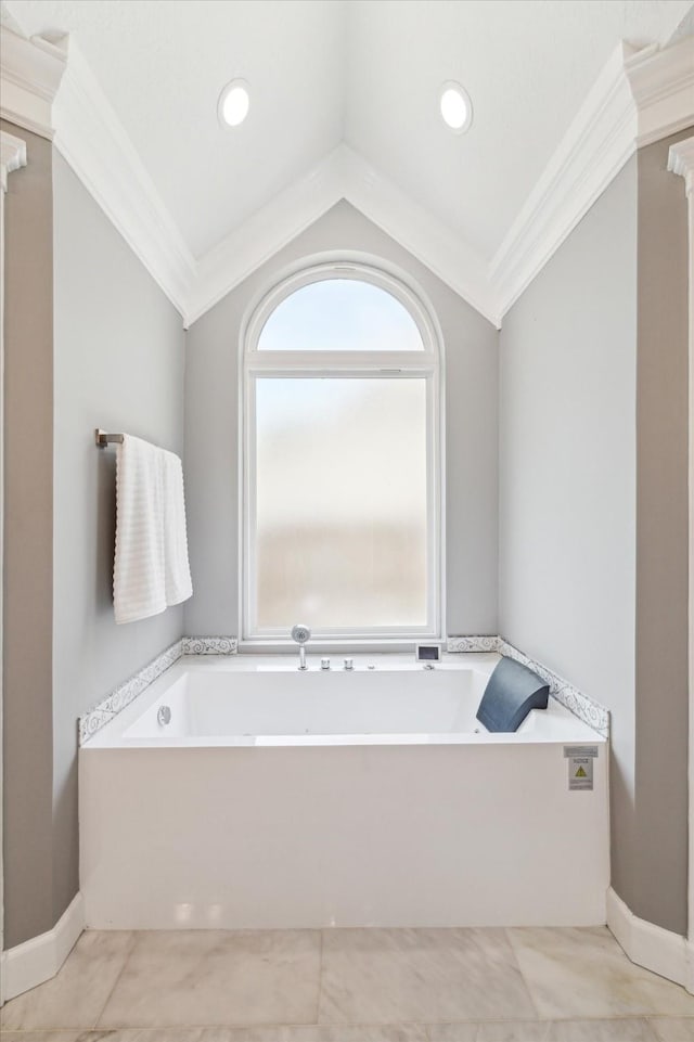 full bathroom featuring ornamental molding, a bath, tile patterned flooring, and vaulted ceiling