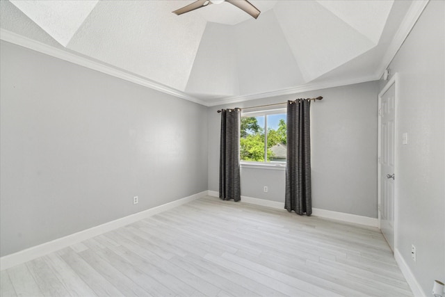 unfurnished room featuring baseboards, a ceiling fan, crown molding, light wood-style floors, and lofted ceiling