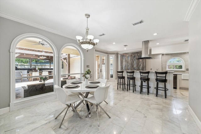 dining room with visible vents, ornamental molding, and plenty of natural light