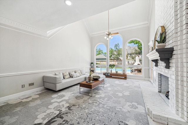 living room featuring crown molding, baseboards, carpet flooring, and a brick fireplace