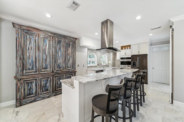 kitchen featuring crown molding, high quality fridge, visible vents, island exhaust hood, and oven