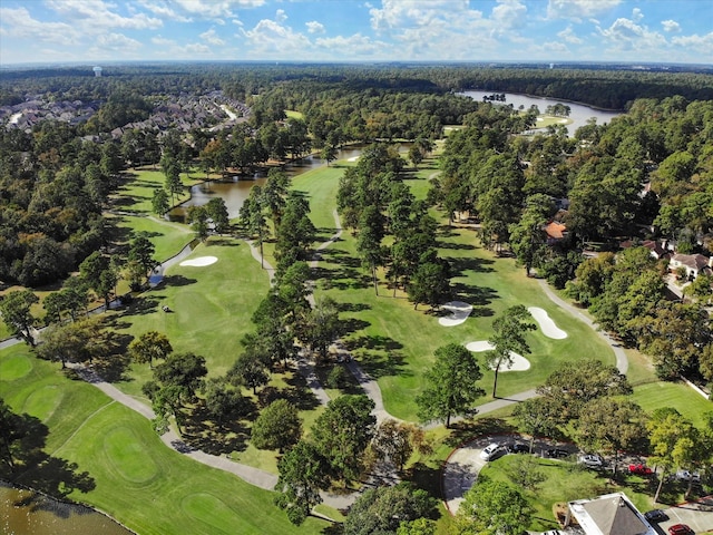 drone / aerial view with view of golf course and a water view