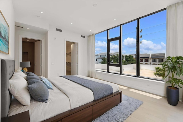 2323 W Main St Unit 305, Houston, TX 77098 - bedroom featuring wood finished floors, recessed lighting, and a spacious closet