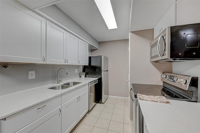 8201 Richmond Ave Unit 50, Houston, TX 77063 - kitchen with light tile patterned floors, white cabinets, a sink, light countertops, and appliances with stainless steel finishes