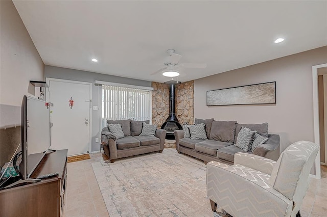 8201 Richmond Ave Unit 50, Houston, TX 77063 - living area with light tile patterned flooring, a wood stove, a ceiling fan, and recessed lighting