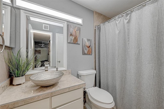 8201 Richmond Ave Unit 50, Houston, TX 77063 - bathroom with vanity, visible vents, curtained shower, and toilet