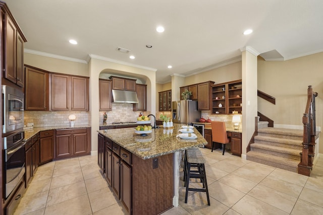 3203 Round Meadow Ln, Missouri City, TX 77459 - kitchen featuring open shelves, under cabinet range hood, visible vents, a breakfast bar area, and stainless steel appliances