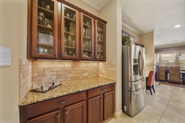 3203 Round Meadow Ln, Missouri City, TX 77459 - bar featuring stainless steel fridge with ice dispenser, light tile patterned floors, tasteful backsplash, and crown molding