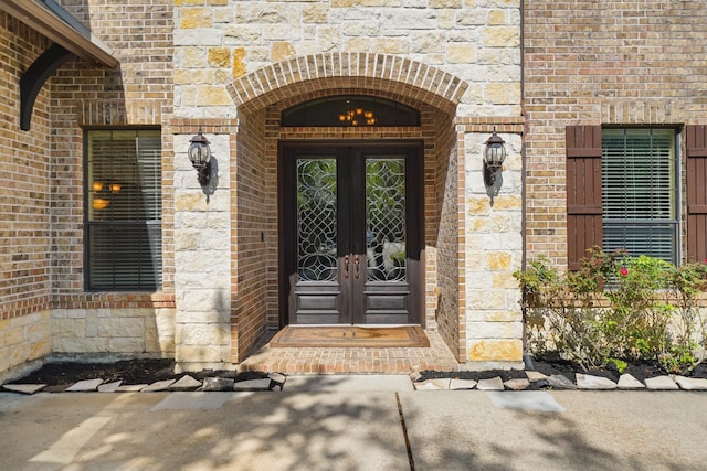 3203 Round Meadow Ln, Missouri City, TX 77459 - view of exterior entry with french doors, stone siding, and brick siding