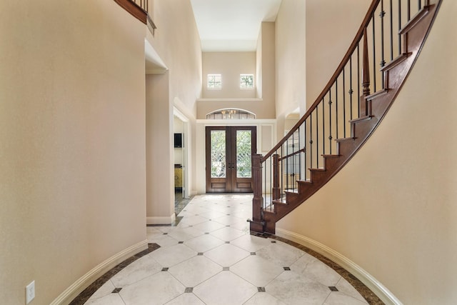 3203 Round Meadow Ln, Missouri City, TX 77459 - foyer featuring a towering ceiling, light tile patterned flooring, stairs, french doors, and baseboards