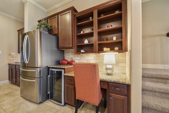 3203 Round Meadow Ln, Missouri City, TX 77459 - kitchen with ornamental molding, light stone counters, stainless steel fridge, open shelves, and beverage cooler