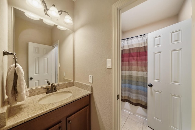 3203 Round Meadow Ln, Missouri City, TX 77459 - full bath with tile patterned floors, shower / tub combo with curtain, vanity, and a textured wall