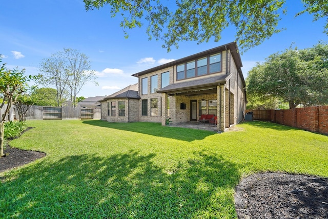 3203 Round Meadow Ln, Missouri City, TX 77459 - back of property featuring brick siding, a fenced backyard, a patio, and a lawn