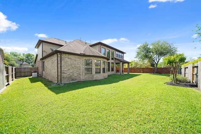 3203 Round Meadow Ln, Missouri City, TX 77459 - back of property with brick siding, a fenced backyard, a shingled roof, and a yard