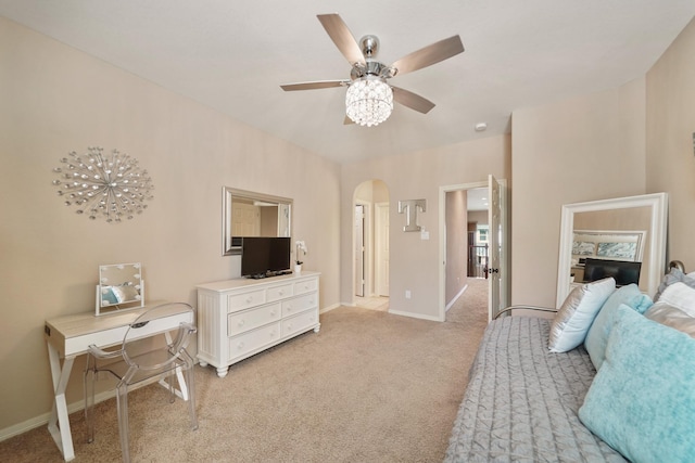 3203 Round Meadow Ln, Missouri City, TX 77459 - bedroom with light carpet, arched walkways, baseboards, and ceiling fan