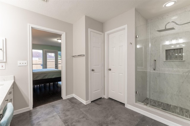 full bath with a shower stall, ensuite bath, vanity, and baseboards