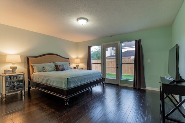 bedroom with access to exterior, baseboards, wood finished floors, and a textured ceiling