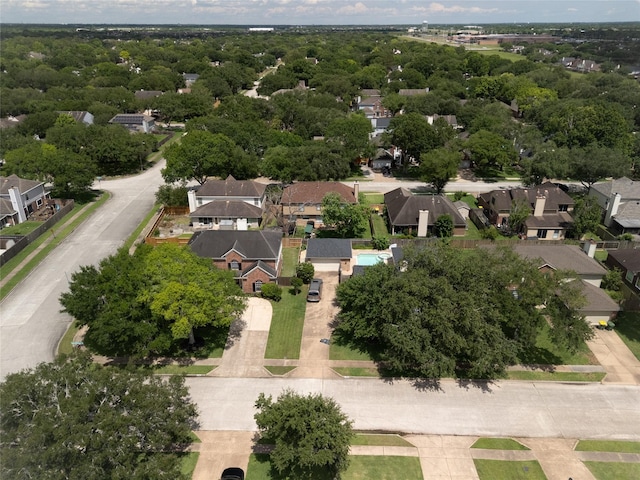 aerial view of property and surrounding area featuring nearby suburban area