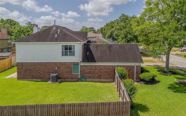 4001 Spring Branch Dr W, Pearland, TX 77584 - rear view of property featuring brick siding, a chimney, cooling unit, and roof with shingles