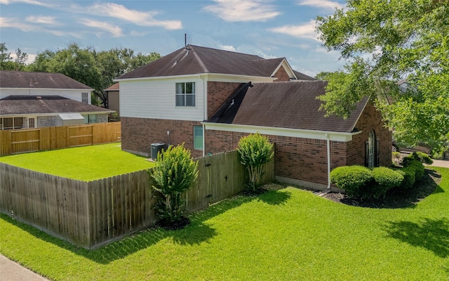 4001 Spring Branch Dr W, Pearland, TX 77584 - rear view of house with brick siding and a shingled roof