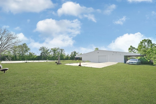 view of yard with an outbuilding, an outdoor structure, and a detached garage