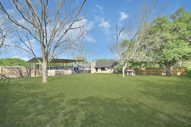 view of yard featuring a fenced backyard and a playground