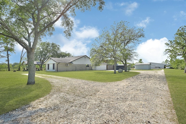 view of front of house with driveway and a front lawn