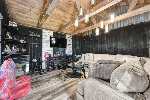 living area with wood walls, vaulted ceiling with beams, wooden ceiling, and wood finished floors