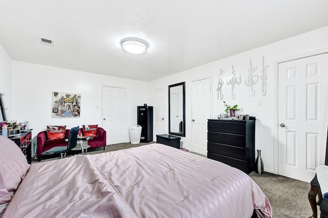 bedroom with carpet flooring, visible vents, and baseboards