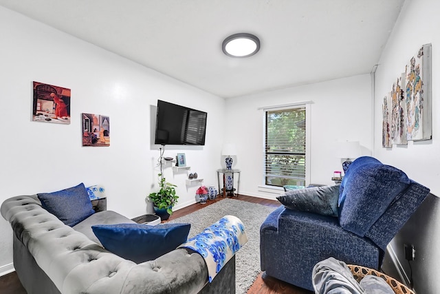living area with wood finished floors and baseboards