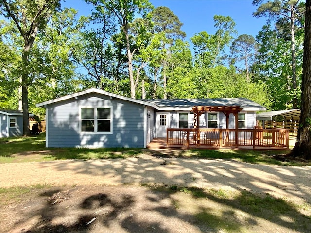 rear view of property featuring a wooden deck