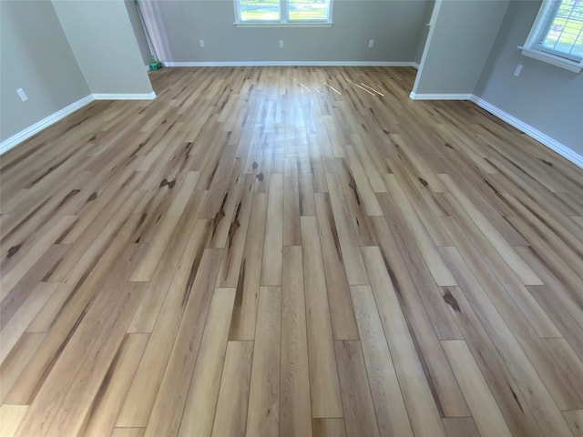 interior space featuring baseboards and wood finished floors